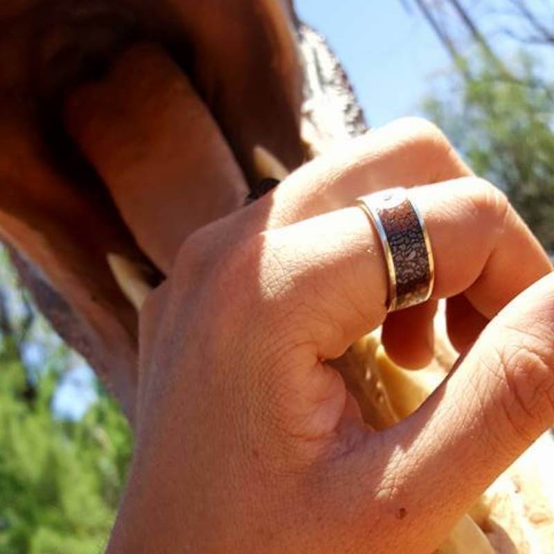 Man wearing dinosaur bone ring