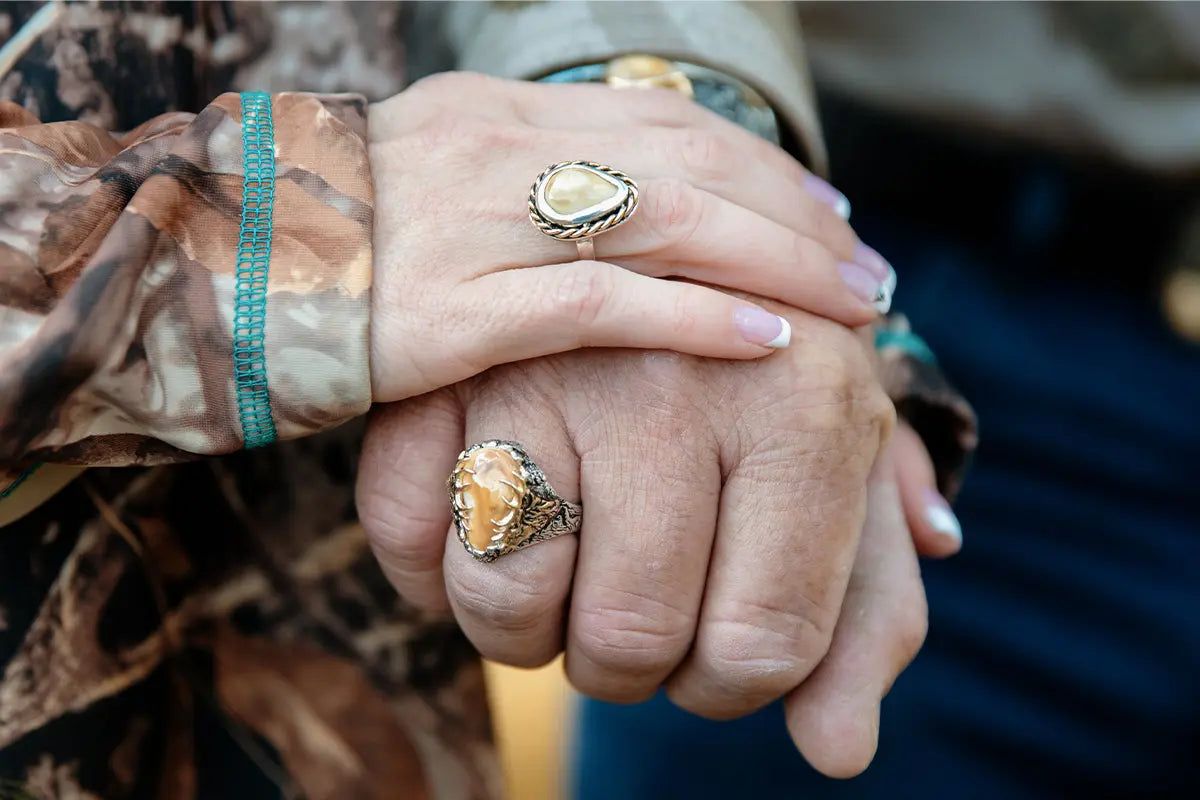 Man and Woman Each Wearing an Elk Ivory Ring from Park City Jewelers