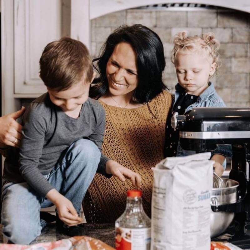 Mother cooking in kitchen with children