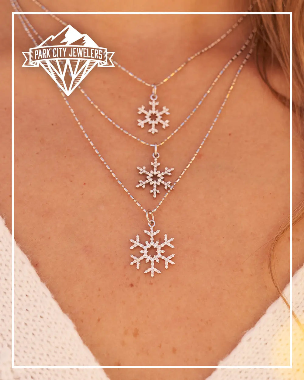 Woman Wearing Three Diamond Snowflake Pendants. 