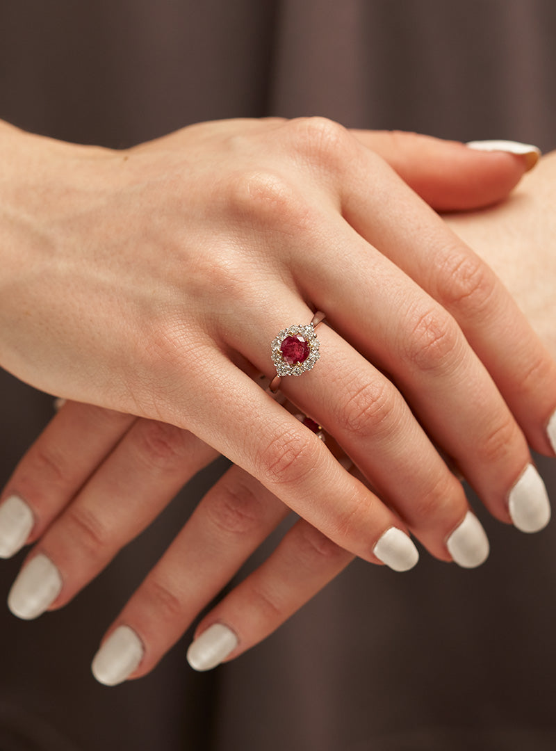 Woman Wearing Red Emerald Ring with a Diamond Halo from Park City Jewelers