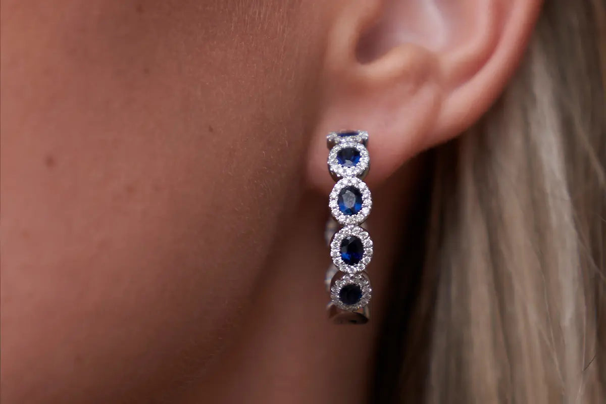 Woman Wearing Sapphire and Diamond Halo Earrings from Park City Jewelers