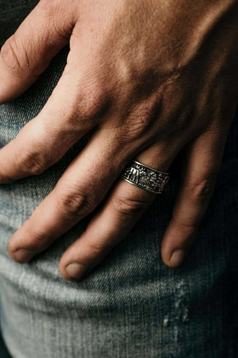 Man wearing wide band mountain themed ring - Park City Jewelers. 