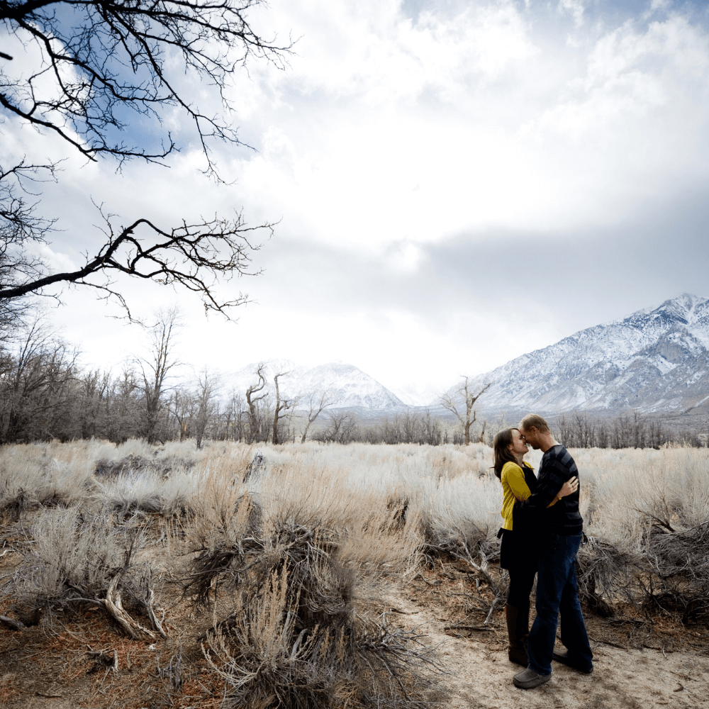 Couple kissing in a winter mountain background