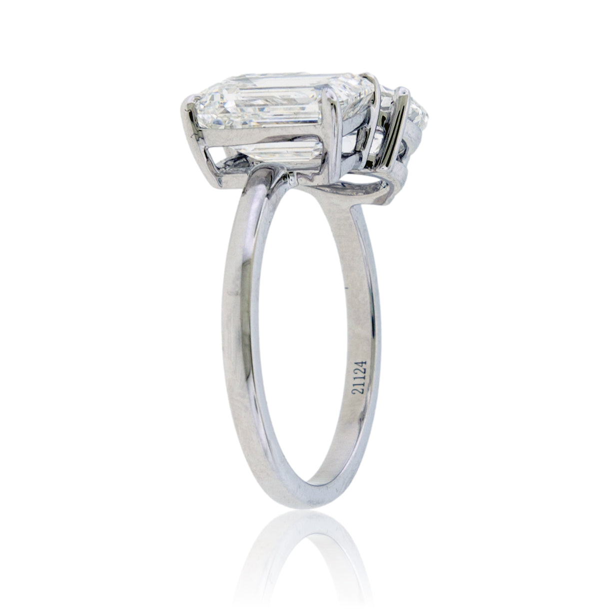 Diamond ring with a rectangular stone on a white background