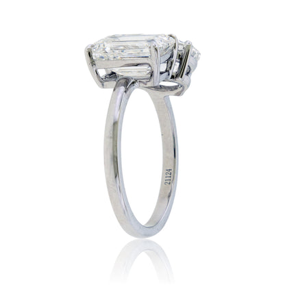 Diamond ring with a rectangular stone on a white background