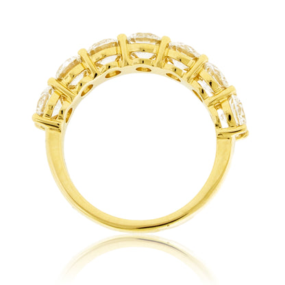 Bottom perspective revealing the open gallery construction, structured prong bases, and polished yellow gold band supporting the setting.