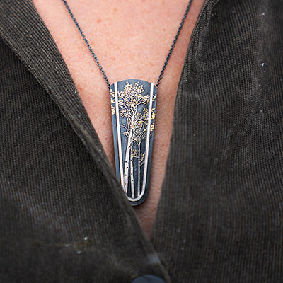 Woman wearing Wolfgang Vaatz sterling silver and gold nugget pendant