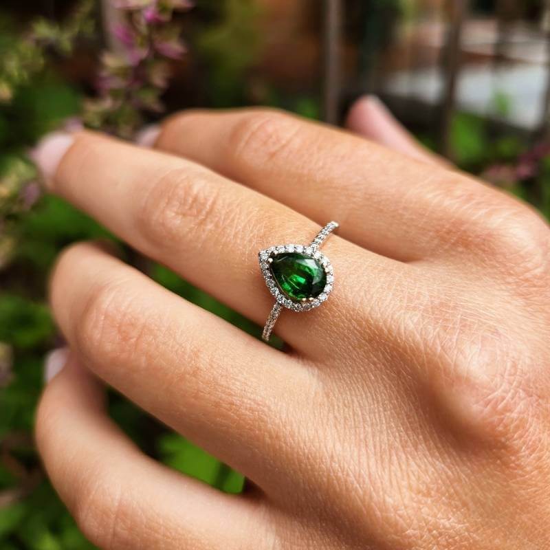 Woman wearing pear shaped tsavorite garnet ring