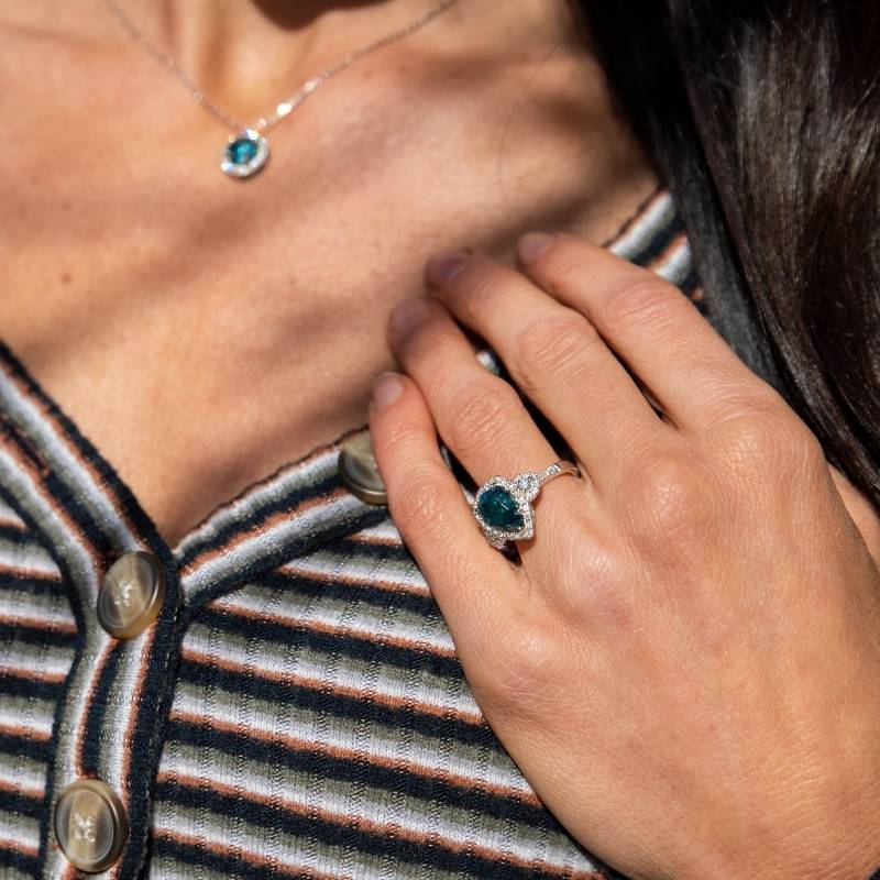 Woman wearing blue zircon ring and necklace