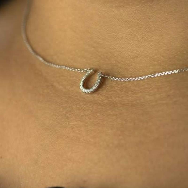 Woman wearing Park City Jewelers horseshoe necklace