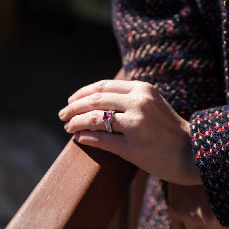 Woman wearing red emerald ring - Park City Jewelers. 