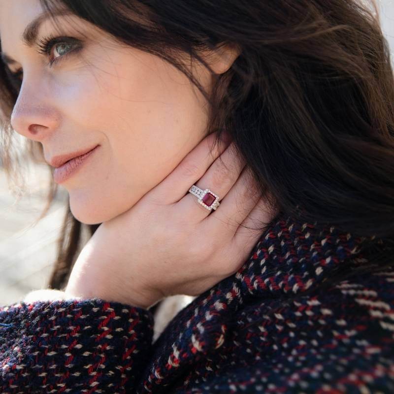 Woman wearing princess cut red emerald ring - Park City Jewelers. 