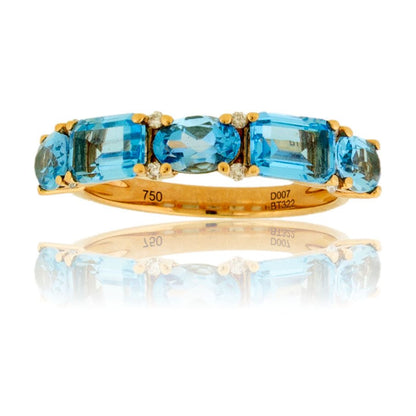 Front view of a five-stone blue topaz ring in 14K yellow gold, featuring an alternating pattern of oval and emerald-cut stones with small diamond accents.