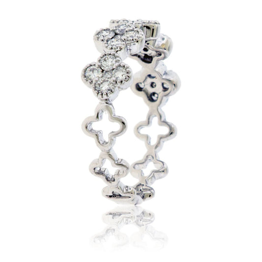 Side profile of a diamond clover band, showing the intricate openwork gallery of connected quatrefoil shapes in 18K white gold.