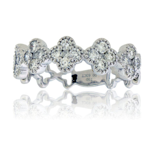 Front view of a diamond clover ring in 18K white gold, featuring a continuous band of pavé-set diamond quatrefoil shapes.