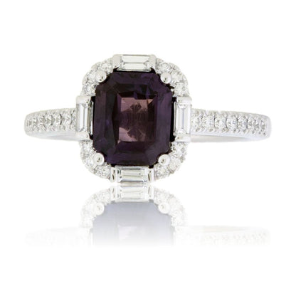 Top-down view of an Art Deco style engagement ring, featuring a large, radiant-cut purple sapphire surrounded by a halo of round and baguette diamonds.