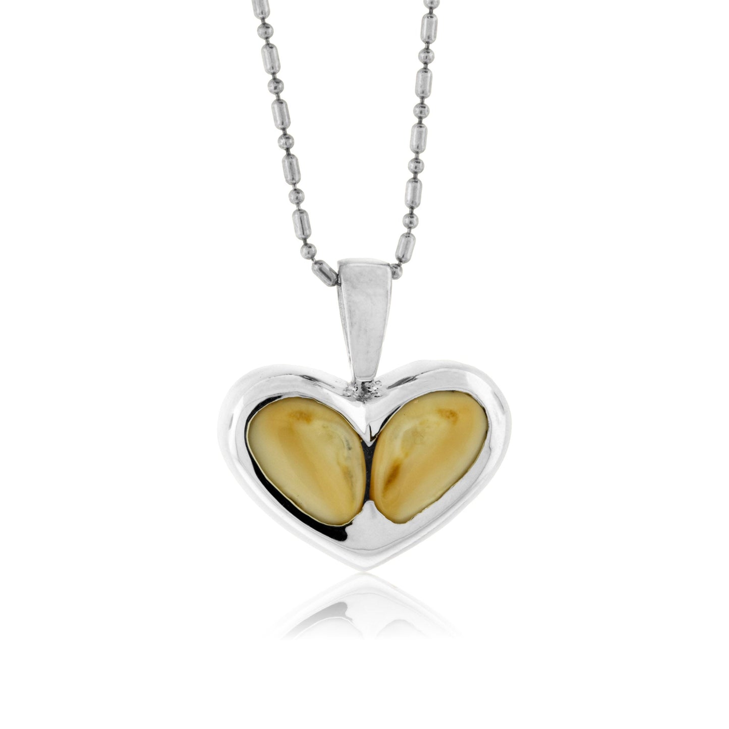 A heart-shaped pendant made from two polished elk ivories, bezel-set in sterling silver and hanging from a ball chain.