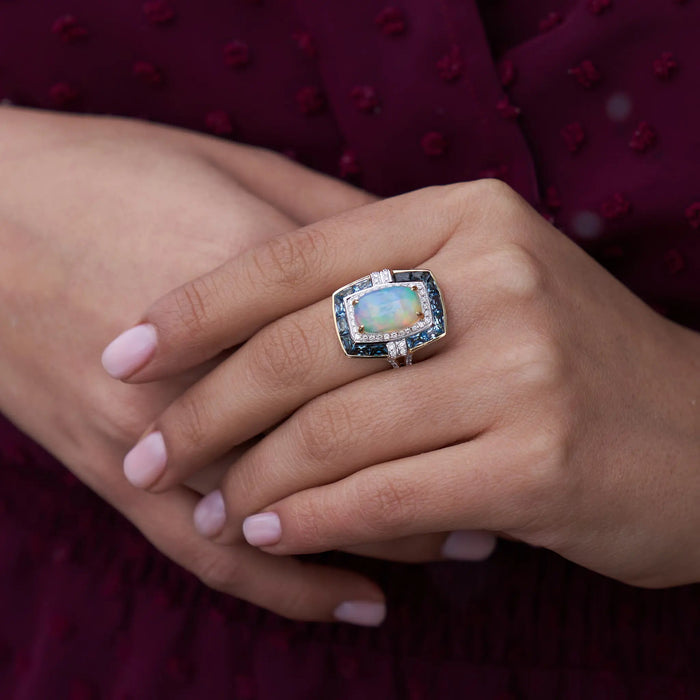 Oval Cabochon Opal Ring with Blue Topaz & Diamond Halo - Park City Jewelers