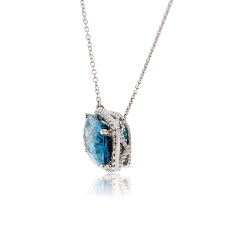 Stunningly Simple Blue Zircon and Diamond Halo Pendant - Park City Jewelers